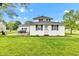 Backyard featuring an exterior view of the house, with an access door, a BBQ and a well-maintained lawn at 301 S B St, Thorntown, IN 46071