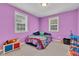 Bedroom featuring carpet, a double bed with various toys and pillows and two windows with blinds at 301 S B St, Thorntown, IN 46071