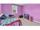 Bedroom featuring carpet, a double bed, a window, and an area to play for  at 301 S B St, Thorntown, IN 46071