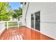 A pristine wooden deck with sliding glass door offers seamless indoor-outdoor living at 301 S B St, Thorntown, IN 46071