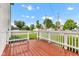 A wooden deck has a bright view of the neighborhood on a lovely day at 301 S B St, Thorntown, IN 46071