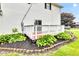 A clean wooden deck surrounded by green hostas adds outdoor living space to this home at 301 S B St, Thorntown, IN 46071