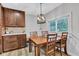 The dining area features wood floors and a mounted television near the window at 301 S B St, Thorntown, IN 46071