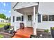 Inviting front porch featuring a charming bench, providing a warm welcome to the home at 301 S B St, Thorntown, IN 46071