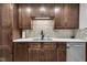 A stylish kitchen showcases wood cabinets, tiled backsplash, and stainless steel appliances at 301 S B St, Thorntown, IN 46071