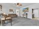 Relaxing living room with neutral-toned sofas, ceiling fan, and natural light for a cozy ambiance at 301 S B St, Thorntown, IN 46071