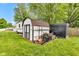 Backyard shed featuring a shed, a camper, and a black container, surrounded by a lawn at 301 S B St, Thorntown, IN 46071