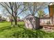 A well-maintained backyard features a neutral-colored storage shed and lush green grass, perfect for outdoor activities at 3027 Ash Way, Lapel, IN 46051