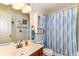 Bathroom featuring a sink, toilet, vanity, mirror, and blue shower curtain at 3027 Ash Way, Lapel, IN 46051
