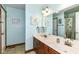 Bright bathroom with a double vanity, linen closet, and tile flooring at 3027 Ash Way, Lapel, IN 46051