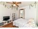 Bright bedroom with wood floors, a bed, and white shelving at 3027 Ash Way, Lapel, IN 46051
