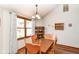 Bright dining room with hardwood floors features a large window and classic wood furniture at 3027 Ash Way, Lapel, IN 46051
