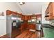 Well-lit kitchen features stainless steel appliances and dark-stained wood cabinetry at 3027 Ash Way, Lapel, IN 46051
