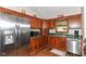 Efficient kitchen featuring wood cabinets, stainless steel appliances, and a cozy window at 3027 Ash Way, Lapel, IN 46051