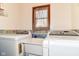 Practical laundry area with washer, dryer, and utility sink for added convenience at 3027 Ash Way, Lapel, IN 46051