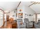 Cozy living room with hardwood floors and vaulted ceiling extends into the dining room at 3027 Ash Way, Lapel, IN 46051