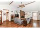 Inviting living room with a brick fireplace, wood floors, vaulted ceilings, and a ceiling fan at 3027 Ash Way, Lapel, IN 46051