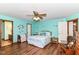 Bright and spacious main bedroom with laminate flooring, ceiling fan, and ensuite bathroom at 3027 Ash Way, Lapel, IN 46051