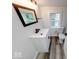 Updated bathroom featuring a stylish vanity, wood look flooring, and a framed mirror at 3132 Indianapolis Ave, Indianapolis, IN 46208