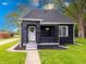 Charming black exterior with lush lawn, flower basket, and a welcoming white door at 3132 Indianapolis Ave, Indianapolis, IN 46208