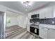 Modern kitchen design with white cabinets, stainless steel appliances, and an open layout at 3132 Indianapolis Ave, Indianapolis, IN 46208