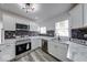 Bright, renovated kitchen with stainless appliances, granite countertops, tile backsplash at 3132 Indianapolis Ave, Indianapolis, IN 46208