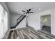 Modern living room featuring stylish staircase, contemporary flooring, and abundant natural light at 3132 Indianapolis Ave, Indianapolis, IN 46208
