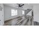 Bright and airy living room featuring modern ceiling fans, stylish floors, and staircase at 3132 Indianapolis Ave, Indianapolis, IN 46208