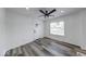 Stylish living room with modern flooring, white door, and natural light from the window at 3132 Indianapolis Ave, Indianapolis, IN 46208