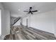 Bright and airy living room featuring modern ceiling fans, stylish floors, and staircase at 3132 Indianapolis Ave, Indianapolis, IN 46208