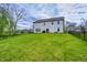 Expansive backyard view showcasing lush green lawn, privacy fencing, and the home's exterior at 3148 Hawking Ct, Danville, IN 46122