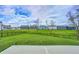 Large, manicured backyard features an expansive lawn, black iron fence, and views of neighborhood homes at 3148 Hawking Ct, Danville, IN 46122
