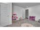 Spacious room with multiple doors, large rug, and a toy doll house at 3148 Hawking Ct, Danville, IN 46122