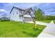 Beautifully landscaped home exterior with a well-manicured lawn, grey garage doors, and a welcoming driveway at 3148 Hawking Ct, Danville, IN 46122