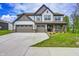 Stunning home exterior showcases a three-car garage, manicured lawn, and inviting front porch at 3148 Hawking Ct, Danville, IN 46122