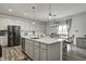 Modern eat-in kitchen featuring a center island, white cabinetry, and stainless steel appliances at 3148 Hawking Ct, Danville, IN 46122
