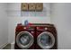 Convenient laundry room with modern washer and dryer, plus storage and counter space at 3148 Hawking Ct, Danville, IN 46122