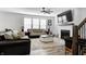 Comfortable living room with a fireplace, large windows, and open access to other parts of the house at 3148 Hawking Ct, Danville, IN 46122