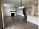 Bright living room with fireplace, wood floors, and modern lighting creates a cozy and inviting space at 3148 Hawking Ct, Danville, IN 46122