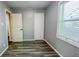 This bedroom features luxury vinyl plank flooring, neutral walls, two doors, and a window at 3322 W 22Nd St, Indianapolis, IN 46222