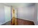 This bedroom offers beautiful wood floors, neutral-colored walls, two doors, and a window at 3322 W 22Nd St, Indianapolis, IN 46222