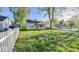 View of house featuring grass, a pile of rocks, and a white picket fence at 3322 W 22Nd St, Indianapolis, IN 46222