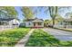 Classic single-story home with a green lawn, a front pathway, and mature trees at 3322 W 22Nd St, Indianapolis, IN 46222