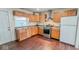 Well-appointed kitchen includes stainless steel appliances, wood cabinetry, and ample counter space at 3322 W 22Nd St, Indianapolis, IN 46222