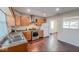 Updated kitchen features stainless steel appliances, wood cabinets, and an open layout to living area at 3322 W 22Nd St, Indianapolis, IN 46222
