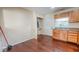 Open floor plan showing kitchen area with wood cabinets and adjacent laundry room at 3322 W 22Nd St, Indianapolis, IN 46222