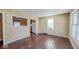 An open living room with hardwood floors, plenty of light, and an opening into the kitchen at 3322 W 22Nd St, Indianapolis, IN 46222