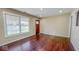 Bright living room with hardwood floors, large windows, and exterior door, freshly painted at 3322 W 22Nd St, Indianapolis, IN 46222