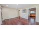 Spacious living room featuring hardwood floors, neutral paint, and an opening to the kitchen at 3322 W 22Nd St, Indianapolis, IN 46222