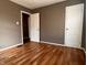 Bedroom featuring hardwood floors, white doors, and a bright window at 3541 Orchard Ave, Indianapolis, IN 46218